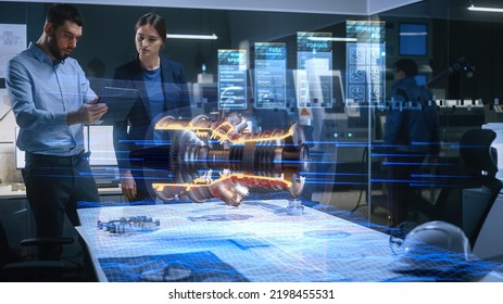 Aeronautics Factory Office Meeting Room: Engineer Holds Tablet Computer, Showing Augmented Reality Airplane Jet Engine to a Female Manager. Modern Industry 4.0 Project Research and Development.