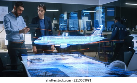 Aeronautics Factory Office Meeting Room: Chief Engineer Holds Tablet Computer, Showing Augmented Reality Airplane to a Female Project Manager, They Test Aerodynamics. Industry 4.0 Research.