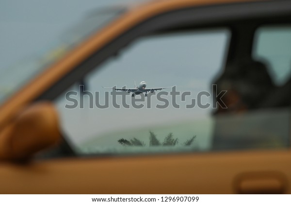 an aeroplane in the\
car frame to land