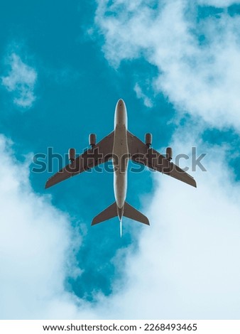 Aeroplane in flight beneath a blue sky with clouds, low flying plane, airbus aircraft