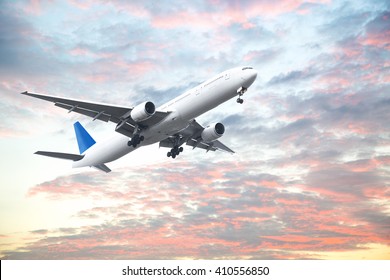 Aeroplane flying in sunset sky with beautiful cloud