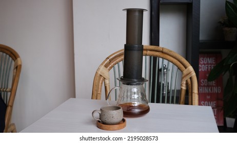 Aeropress Cofee Maker And Coffee Server With A Small Cup On A White Table. Jakarta, 28 August 2022.