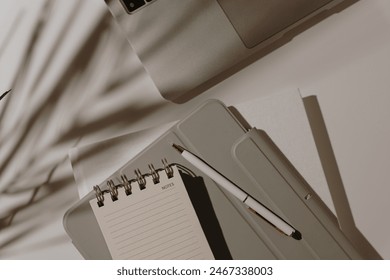 Aesthetic artist home office workspace. Laptop computer, notebook with blank sheet, floral sunlight shadows. Flat lay, top view mock up with copy space - Powered by Shutterstock