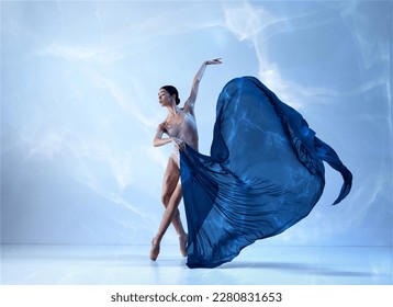 Aesthetic of classical dance. One adorable ballerina wearing beige bodysuits emotional dancing with fabric silk. Concept of classic ballet, inspiration, beauty, dance, creativity - Powered by Shutterstock