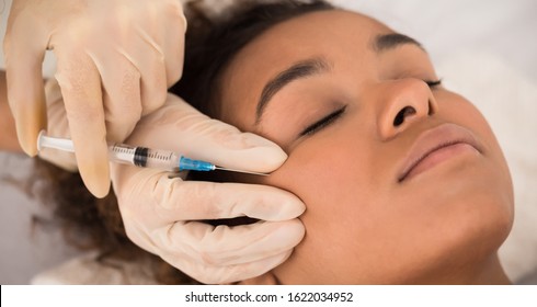 Aesthetic Cosmetology. Black Woman Getting Beauty Facial Injections In Cheekbones