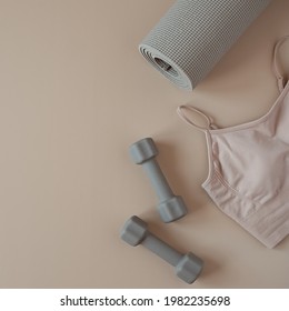 Aesthetic creative flat lay of yoga, fitness, workout training equipment on neutral beige background. Dumbbells, top, mat. Flatlay, top view sport influencer concept - Powered by Shutterstock