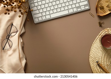 Aesthetic Feminine Workspace With Keyboard, Candle, Dried Flowers, Glasses, Office Supplies. Stylish Home Office Desk Table. Flat Lay, Top View.