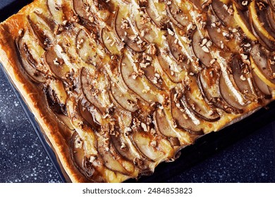 Aesthetic freshly baked homemade pie with puff pastry, pear slices, camembert, honey, walnuts close up. - Powered by Shutterstock