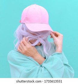 Aesthetic girl in stylish accessories b-boy cap. Fresh pastel colours monochrome fashion design trends