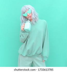 Aesthetic girl in stylish accessories sunglasses and fresh Smoothie. Aqua Menthe monochrome colours design