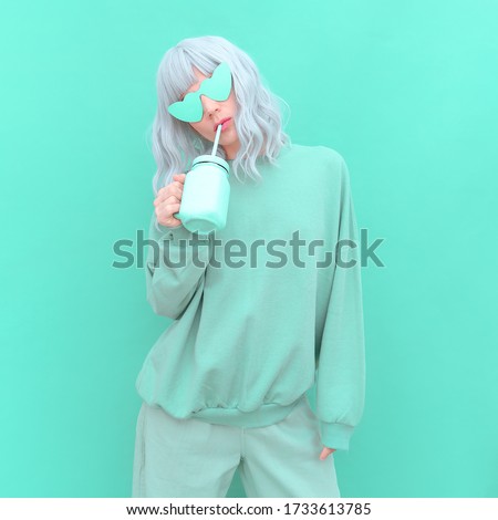 Aesthetic girl in stylish accessories sunglasses and fresh Smoothie. Aqua Menthe monochrome colours design