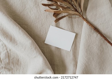 Aesthetic luxury bohemian branding or invitation card template. Blank paper, invitation card sheet with empty mock up copy space, dried protea flower on neutral beige crumpled linen cloth - Shutterstock ID 2172712747