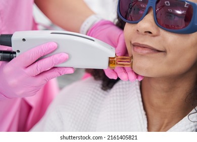 Aesthetic Medicine Doctor Holding A Laser Epilator On Female Face