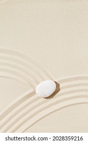 Aesthetic Minimal Background With Zen Stone On Sand. Pattern In Japanese Zen Garden With Concentric Circles Around White Pebble For Meditation And Tranquility. View From Above.