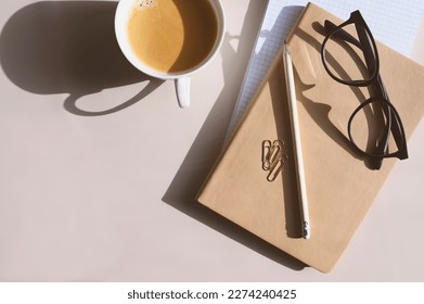 aesthetic minimalist workspace. Home office, blog, social media concept. Note book, coffee and glasses in soft pastele colors - Shutterstock ID 2274240425