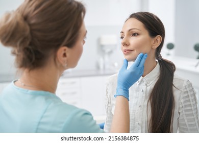 Aesthetic Therapist Checking Woman Face Skin In Cosmetology Clinic