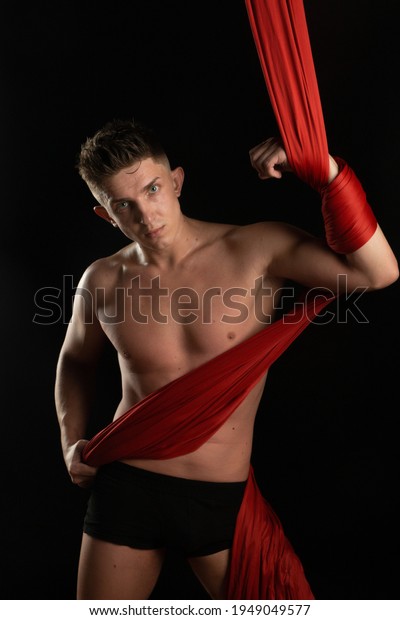 aesthetics of the body, gymnast with red\
cloth, gymnast on a black\
background