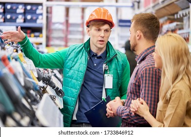 Affable Caucasian Male Warehouse Worker Consult And Help To Customers, Show The Best Variant Of Product In Stock, Married Couple Ask Questions, Interested In Commodity