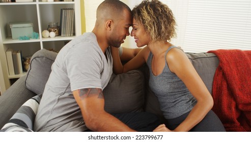 Affectionate African American Couple Talking On Couch