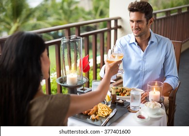 Affectionate couple having dinner on the balcony tropical resort