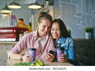Affectionate dates with cellphone sitting in cafe