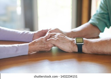 Affectionate and devoted senior spouses holding by hands
