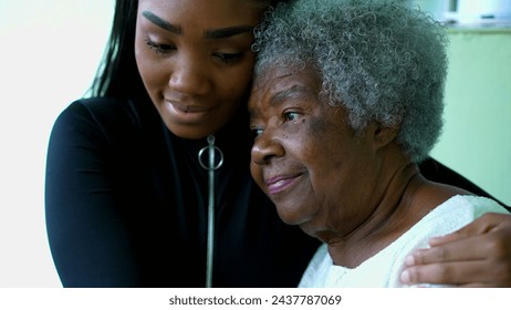 Affectionate Embrace of African American Grandmother by Teenage Granddaughter, inter-generational family member taking care of senior wrinkled woman with gray hair in 80s - Powered by Shutterstock