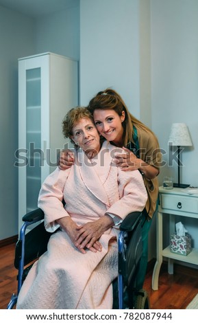 Female caretaker posing with elderly patient