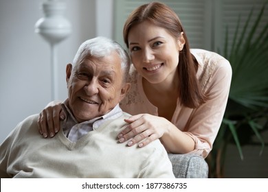 Affectionate grownup daughter embrace retired elderly dad sharing optimism positive emotions. Tender young woman hug beloved old grandfather dreaming together of good happy future long healthy life