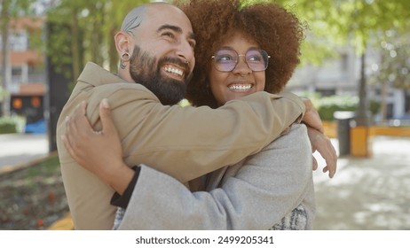 An affectionate interracial couple embraces joyfully in a sunny urban park, reflecting a beautiful moment of love and togetherness in the city. - Powered by Shutterstock