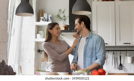 Affectionate Loving Couple Enjoying Free Tender Moment, Preparing Healthy Fresh Food Meal Together At Weekend. Happy Family Spouses Cooking Vegetarian Dish In Modern Kitchen, Healthcare Concept.