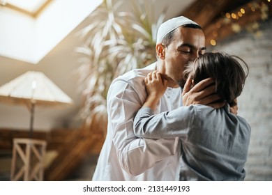 Affectionate Middle eastern father kissing daughter's forehead at home.  - Powered by Shutterstock