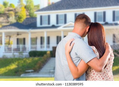 Affectionate Military Couple Looking at Beautiful New House.