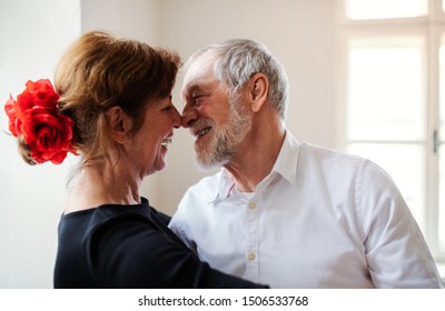 Affectionate Senior Couple Attending Dancing Class In Community Center.