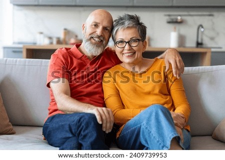 Similar – Image, Stock Photo Senior couple sitting on sofa at home having a relationship problems