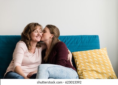 Affectionate Teen Daughter Kissing Her Loving Mother