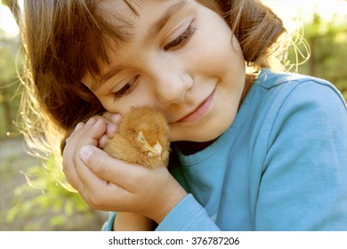 Affectionate Tender Girl Holding Chicken In Hands Like A Treasure