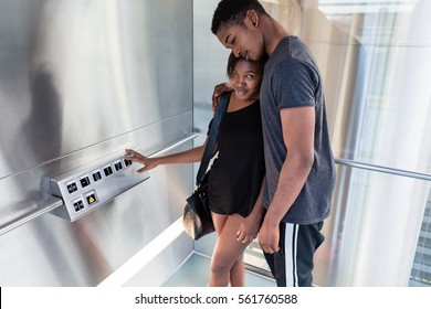 Affectionate Young Black Couple Standing In A Modern Elevator