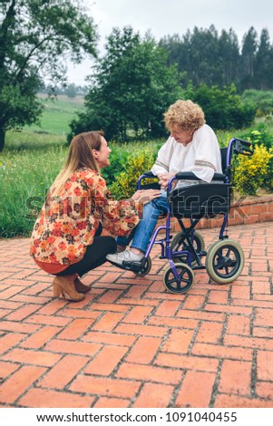 Similar – Granddaughter running to grandmother in wheelchair