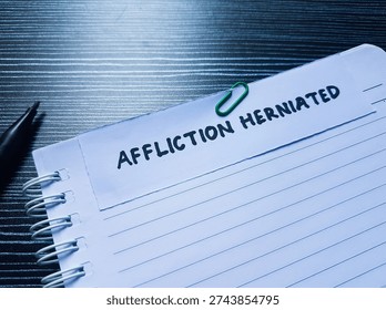 Affliction herniated writting on table background. 