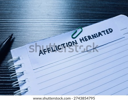 Affliction herniated writting on table background. 