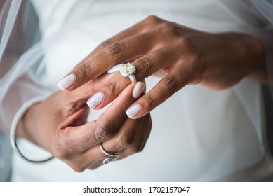 Affluent African American Mixed Race Bride Putting On Yellow Diamond Wedding Ring | Close Up