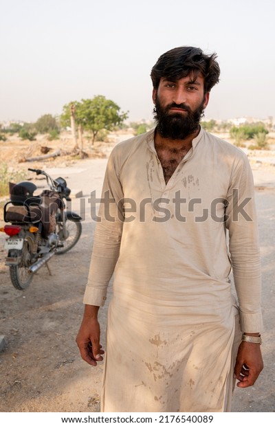 Afghan man working as rider posing for Camera -\
Karachi, Pakistan