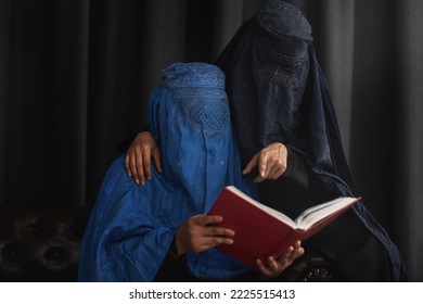 Afghan Muslim women with burka traditional costume, reading holy  Quran against the dark background  - Powered by Shutterstock