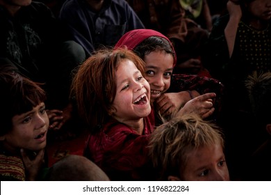  Afghan refugee girl smile in an Afghan refugee camp in Lahore, Pakistan December 08, 2014.
