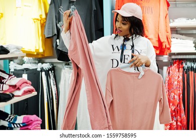 Afican american women in tracksuits shopping at sportswear mall against shelves. Sport store theme. - Powered by Shutterstock