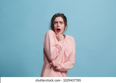 I'm afraid. Fright. Portrait of the scared woman. Business woman standing isolated on trendy blue studio background. Female half-length portrait. Human emotions, facial expression concept. Front view