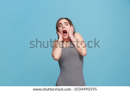 I'm afraid. Fright. Portrait of the scared woman. Business woman standing isolated on trendy blue studio background. Female half-length portrait. Human emotions, facial expression concept. Front view