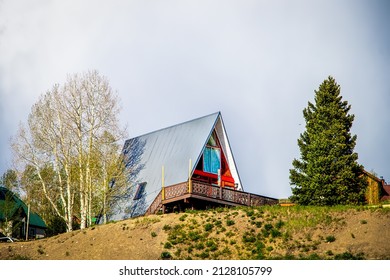 Aframe House On Top Of Hill With Aspen And Evergreen Trees In Ski Resort Village In Colorado USA