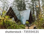 A-Frame structure covering picnic tables in a forest park. Portland, Oregon, USA.